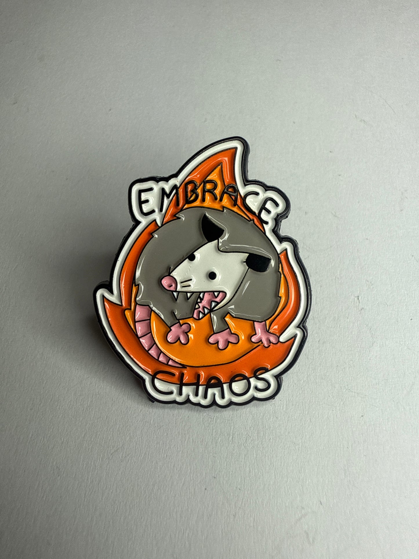 “Embrace chaos” possum pin