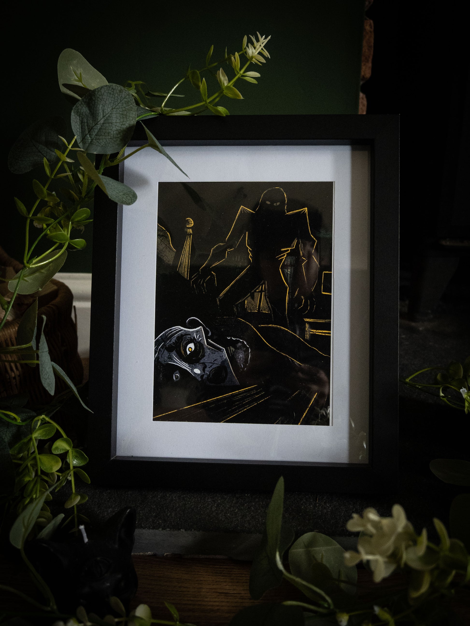 Framed gothic art print of Elizabeth's murder on her wedding night, looming creature in gold linework over prone figure, from Sophie Atkinson's Frankenstein Illustrated series