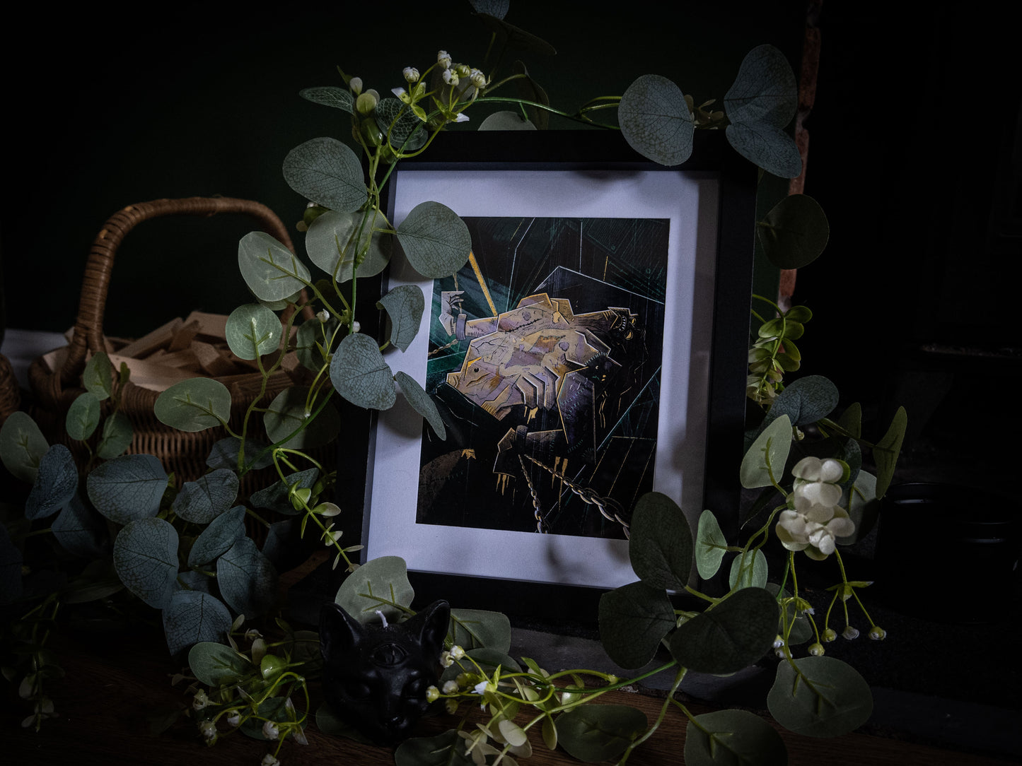 Close-up of Frankenstein illustration print in black frame, bold woodblock-style artwork showing the Creature's awakening, styled with botanical foliage