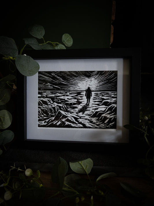 The Ice Plain giclée print displayed with eucalyptus foliage, high-contrast gothic illustration by Sophie Atkinson