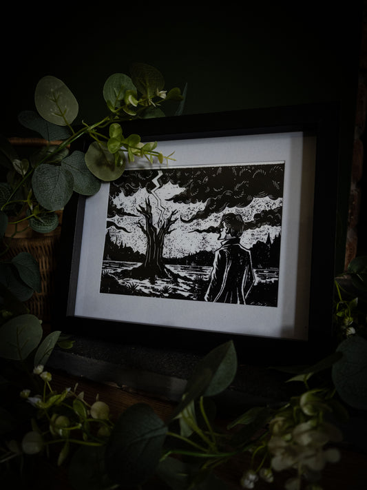 The Lightning Tree giclée print displayed with eucalyptus foliage, high-contrast gothic illustration by Sophie Atkinson