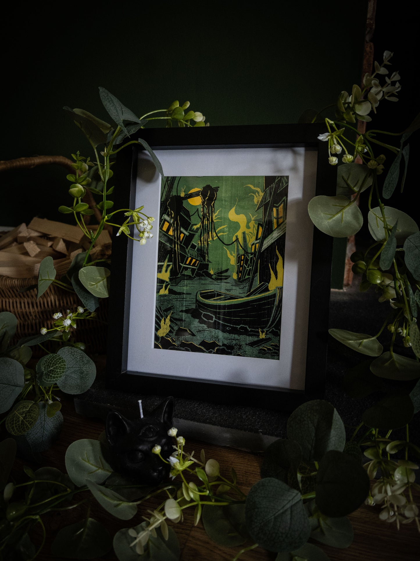 Something Wrong in Innsmouth gothic Lovecraft art print in black frame – decaying harbour with tentacled creature and yellow flames, styled with eucalyptus