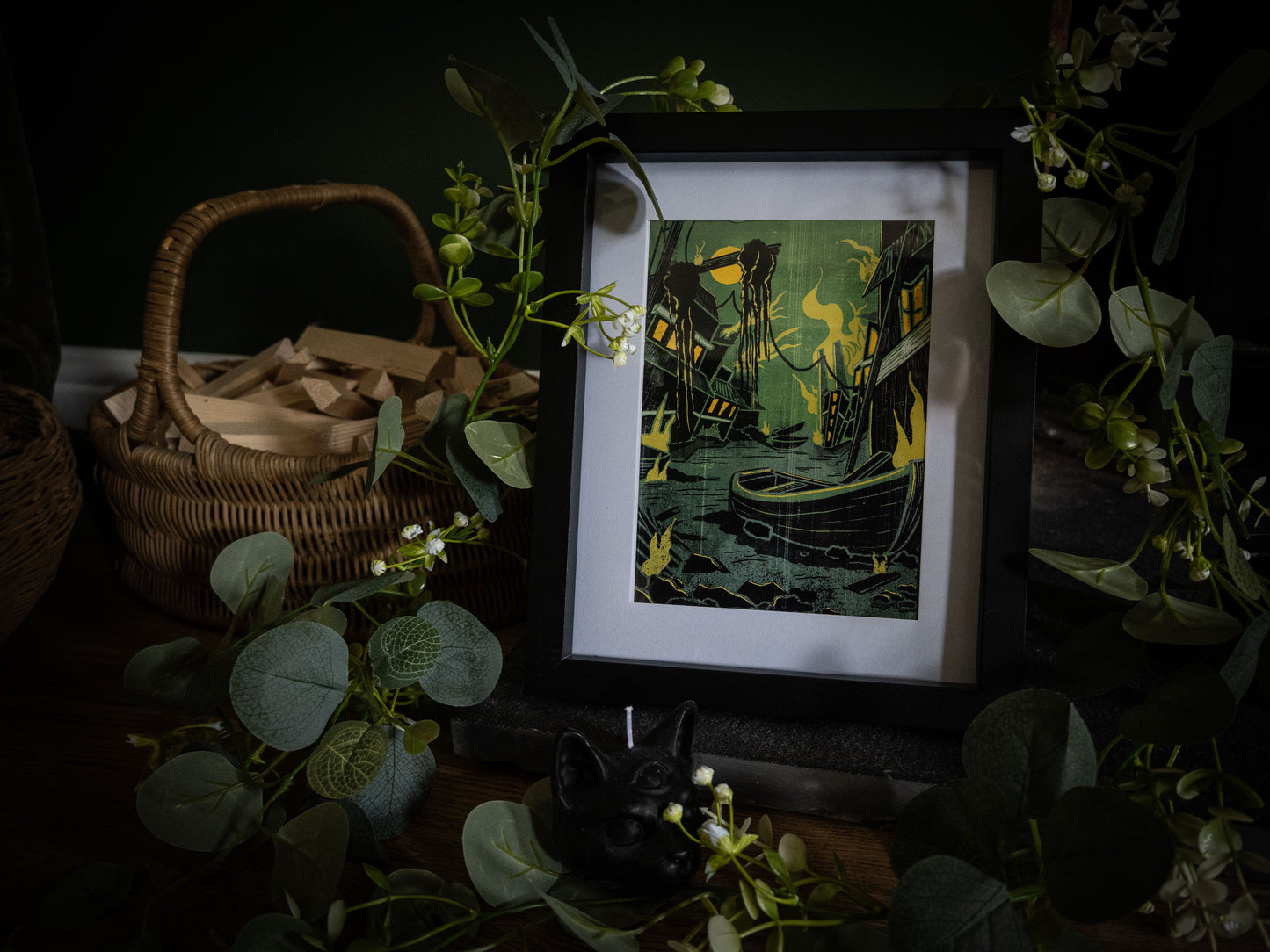 Close-up of Something Wrong in Innsmouth framed print – bold green and black linocut-style illustration of Innsmouth docks with sickly yellow lantern light