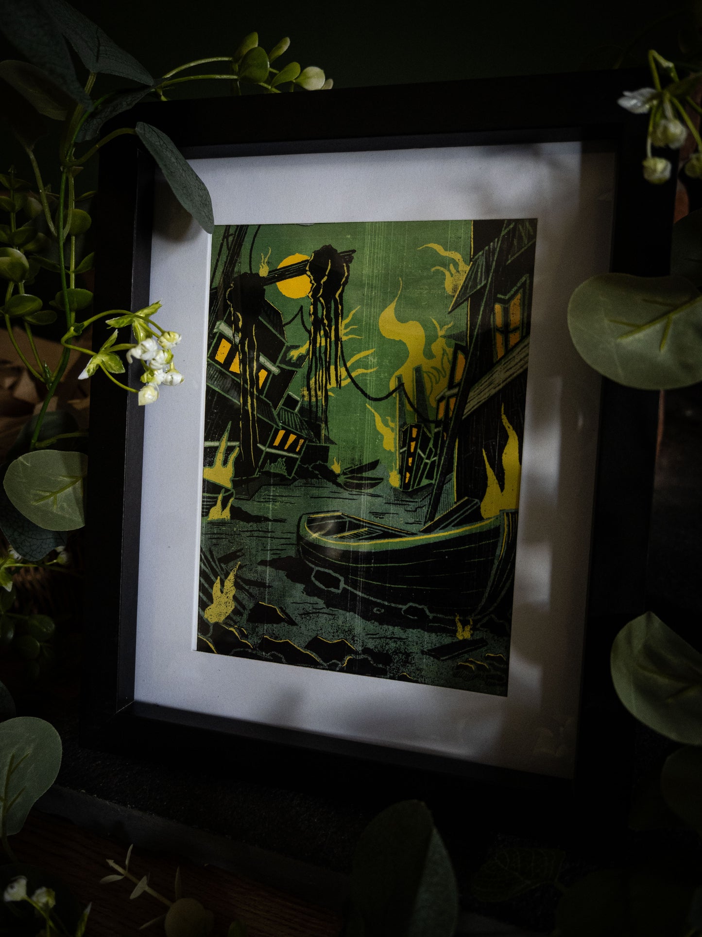 Something Wrong in Innsmouth fine art print – H.P. Lovecraft illustration in black frame, styled with eucalyptus and wicker basket on dark background