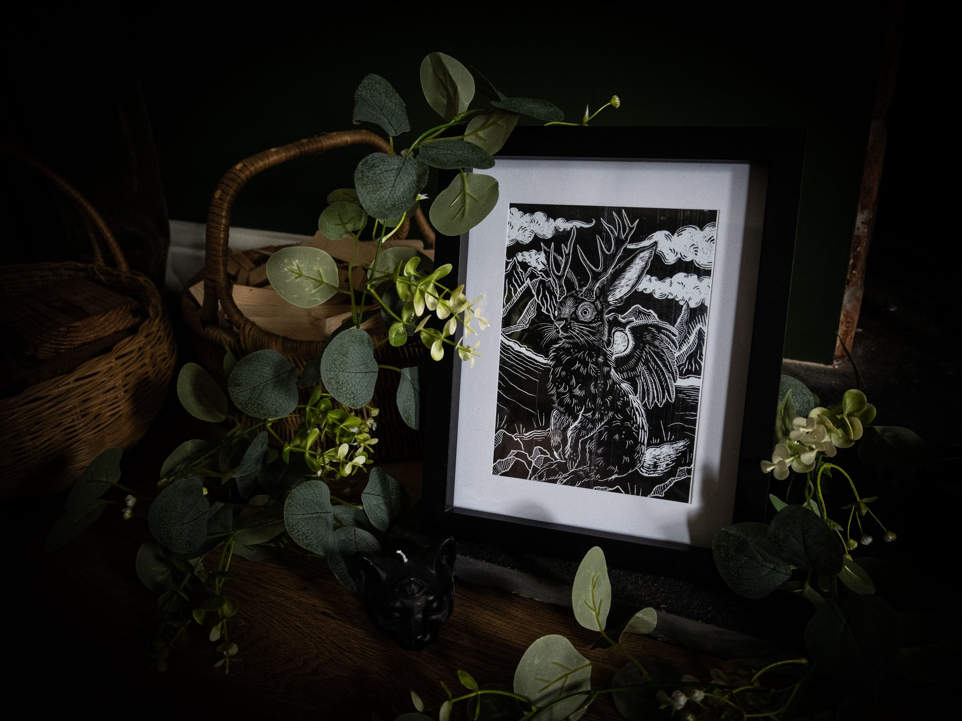 Framed Jackalope gothic illustration print by Sophie Atkinson, moody dark background with eucalyptus leaves and wicker basket
