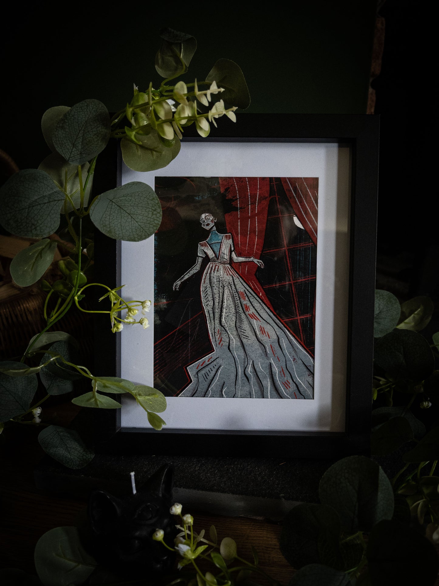 The Lady Ligeia fine art print in black frame – gothic Poe illustration with crimson and grey tones, angled product shot with botanical styling