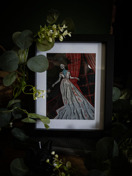 The Lady Ligeia fine art print in black frame – gothic Poe illustration with crimson and grey tones, angled product shot with botanical styling