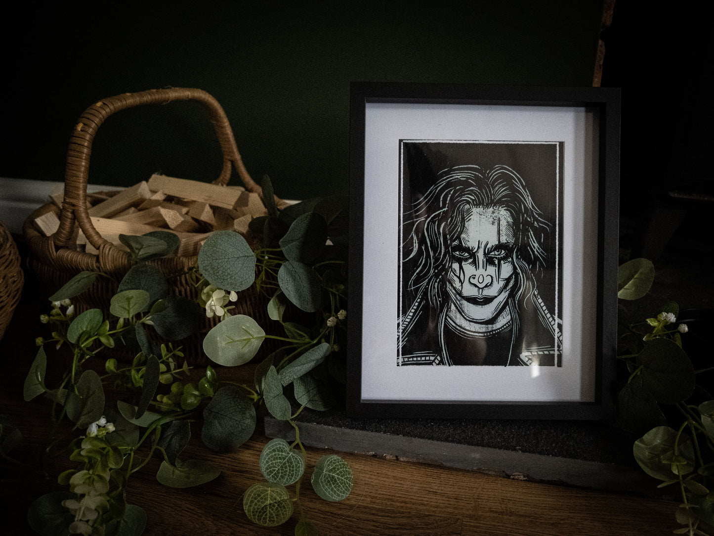 The Crow Eric Draven art print in black frame with eucalyptus foliage