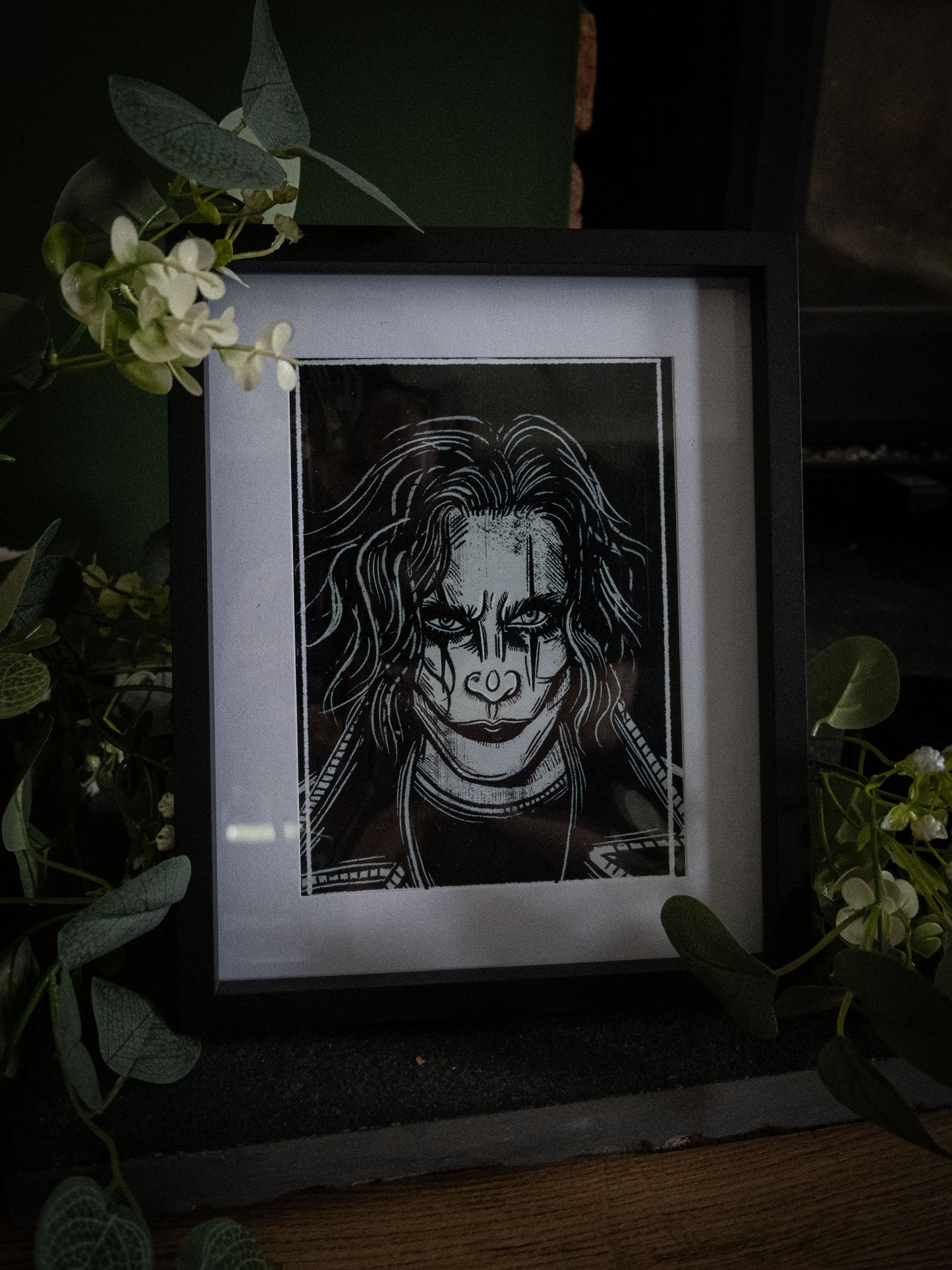 The Crow art print framed, styled with eucalyptus and white blooms