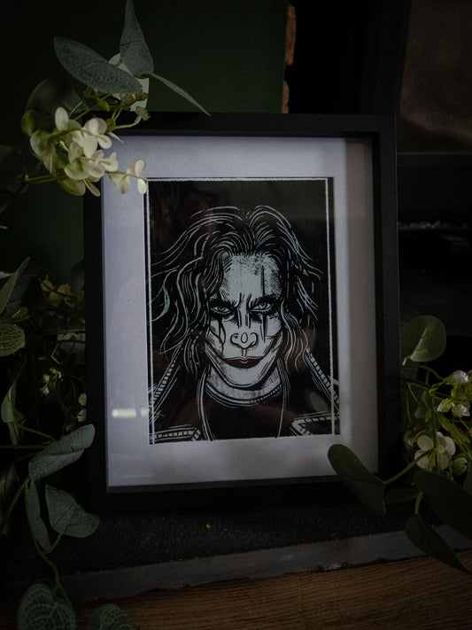 The Crow art print framed, styled with eucalyptus and white blooms
