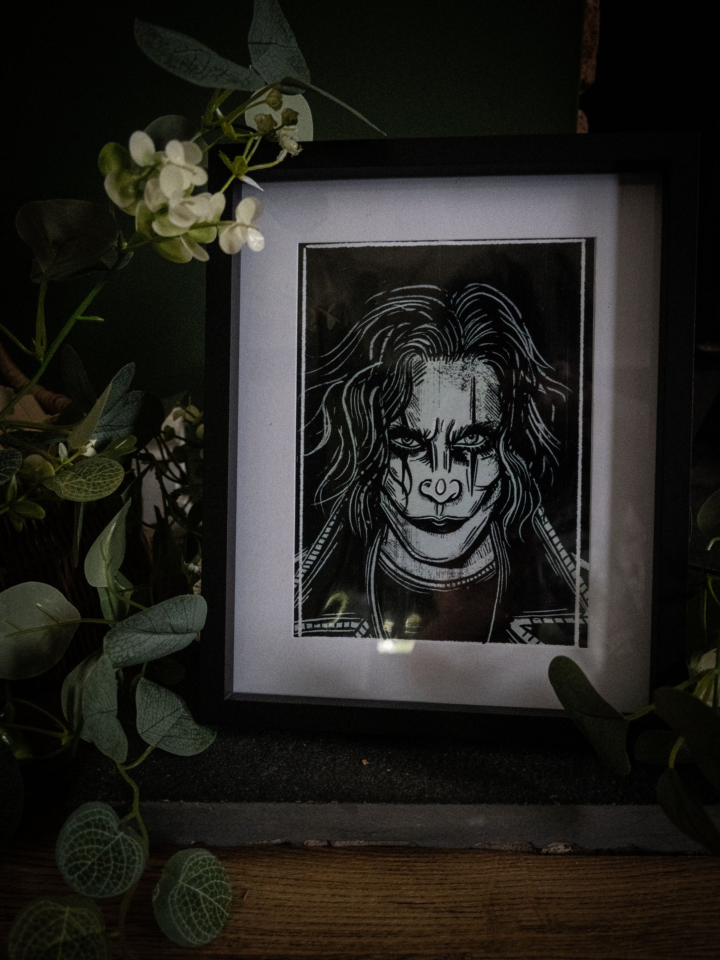 The Crow gothic horror print framed in black with ivy and foliage