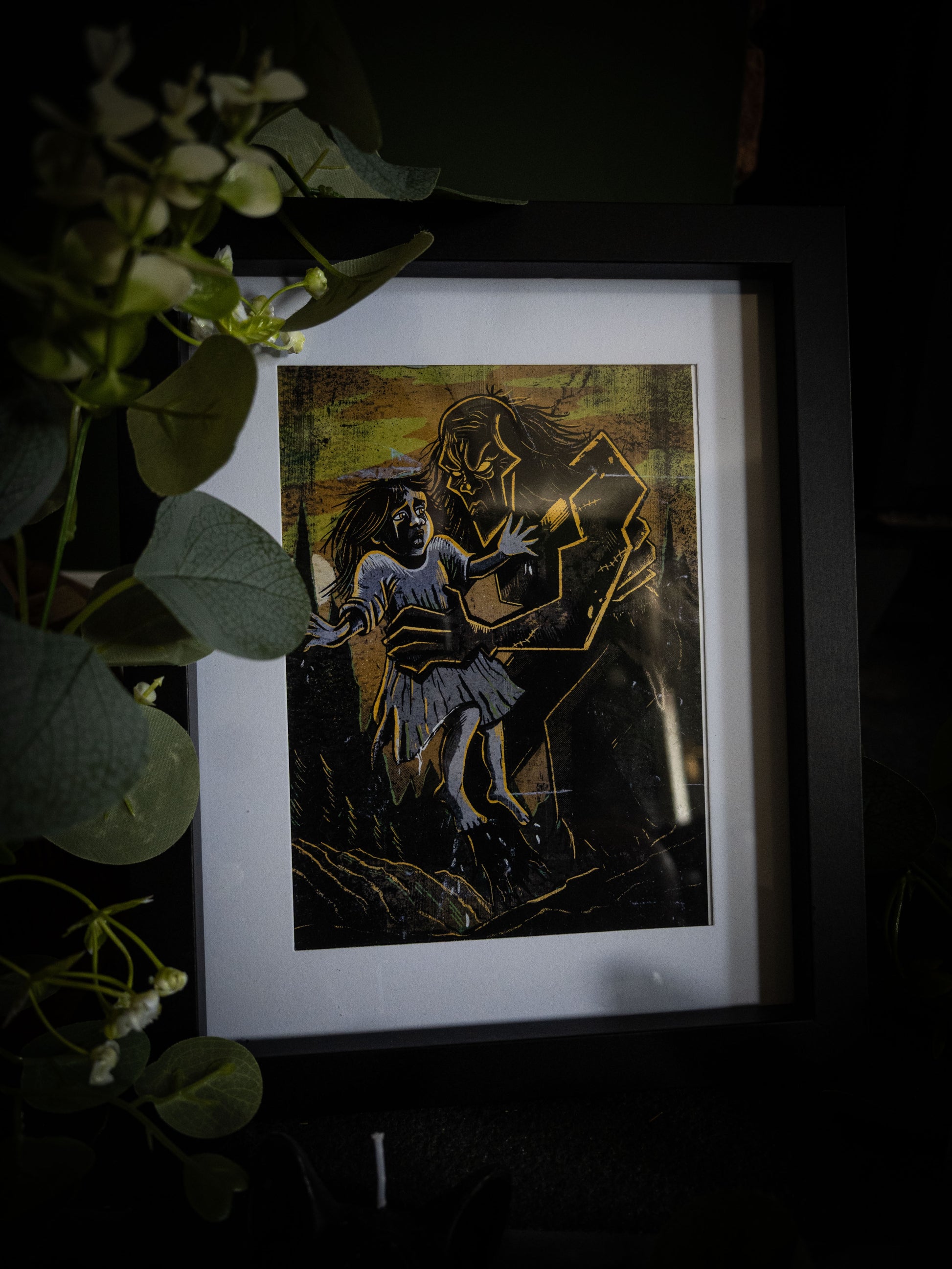The Rescue giclée print in black frame with eucalyptus foliage, gothic horror illustration by Sophie Atkinson
