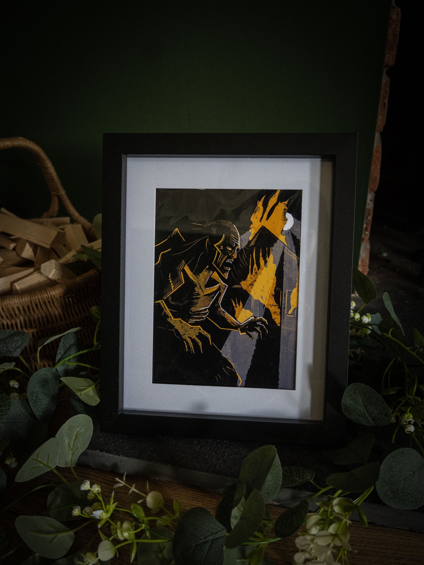 Close-up of The Creature in the Flames framed print – bold black and gold Frankenstein illustration with snarling creature and crescent moon by Sophie Atkinson