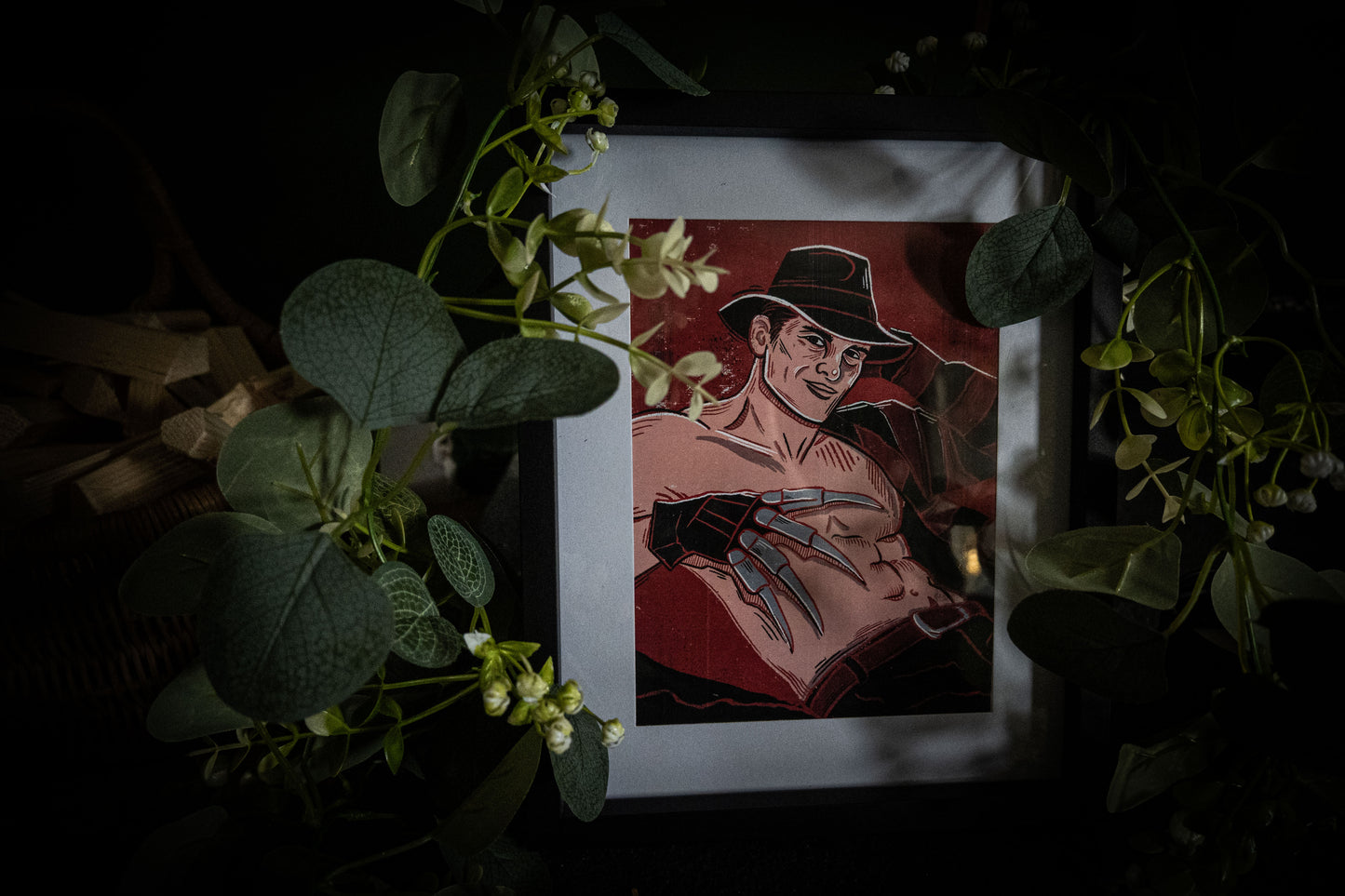 Sexy Freddy Krueger pinup print in black frame — A Nightmare on Elm Street gothic art, framed lifestyle shot