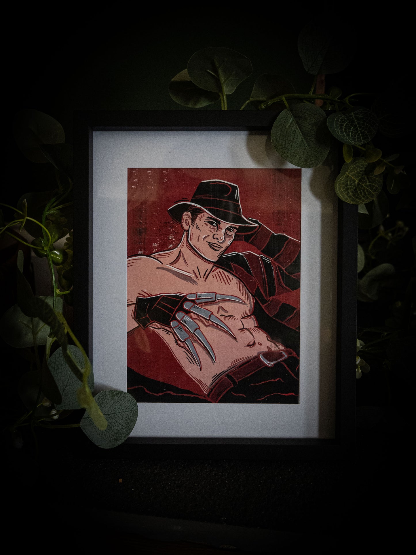Freddy Krueger pinup fine art print in white frame with basket and foliage — horror wall art by Sophie Atkinson Illustration
