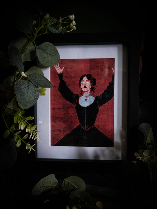 Mina Harker illustrated book art print in black frame, moody dark background with botanical props, figure with arms raised in dramatic pose