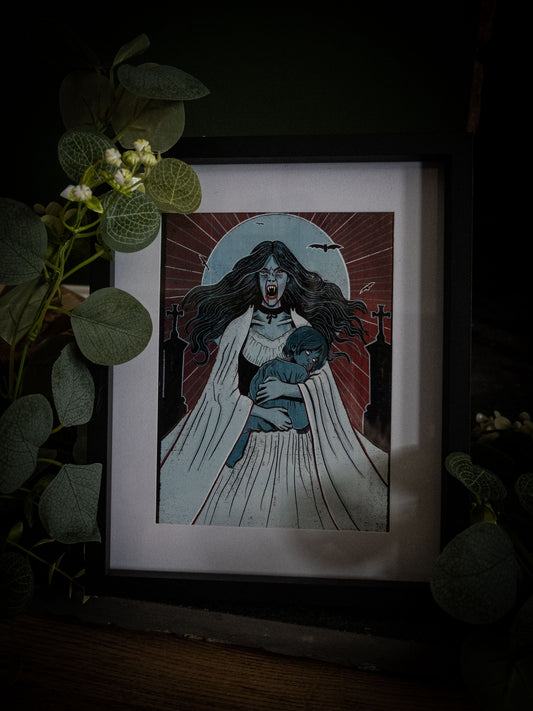 Lucy Westenra gothic vampire print in black frame on wooden surface