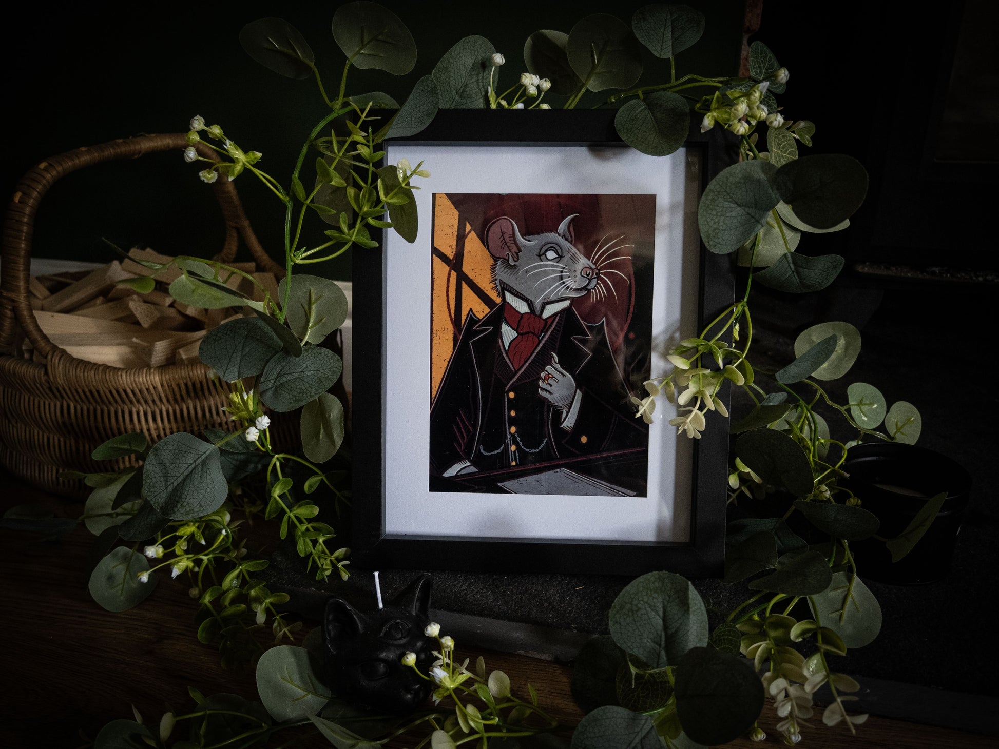 Mr. Whiskers Esq. gothic Victorian rat art print in black frame, styled with eucalyptus and wicker basket on dark background
