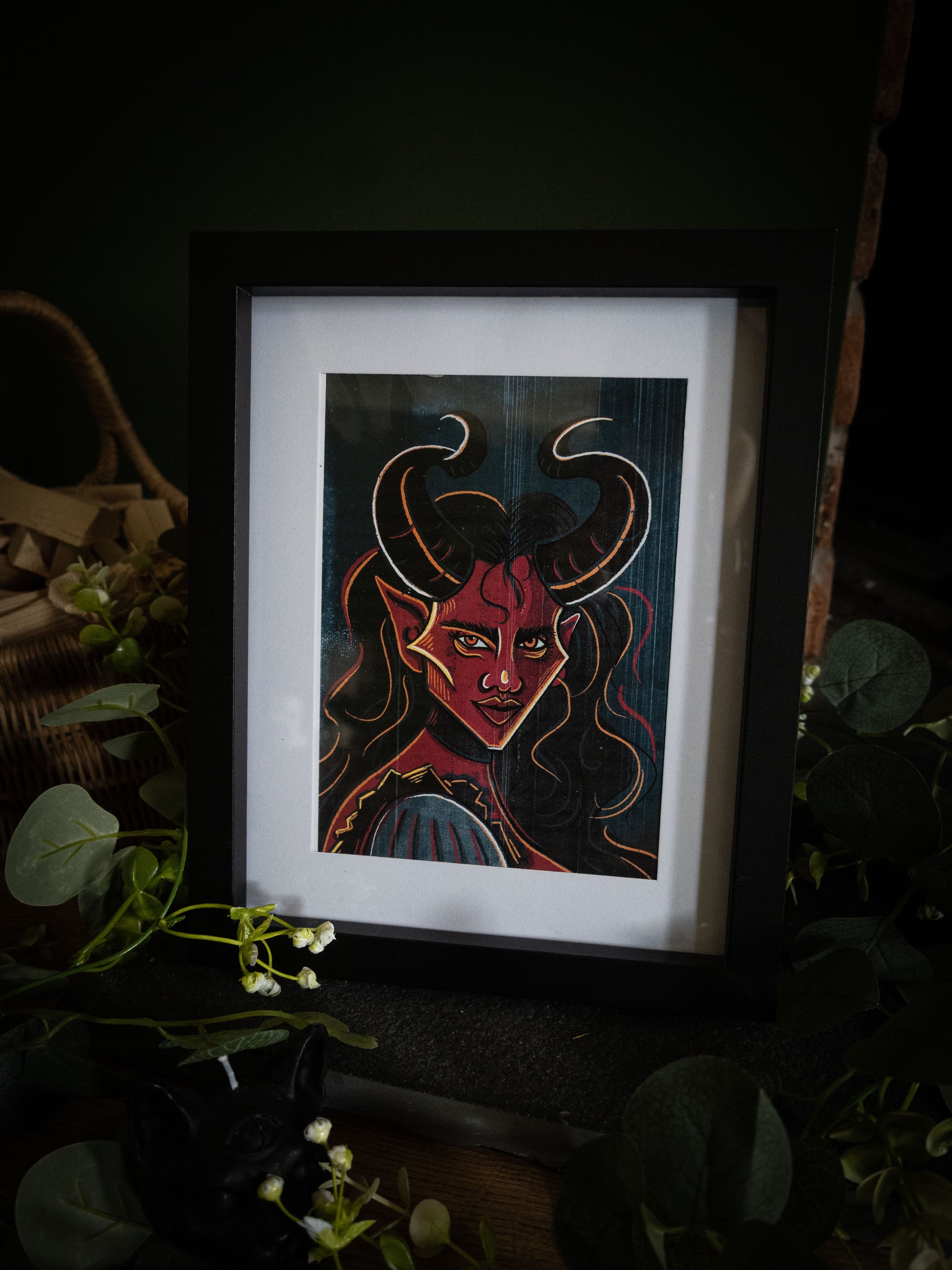 Close-up of The Horned Temptress framed print – bold gothic demon portrait with golden eyes and flowing dark hair by Sophie Atkinson