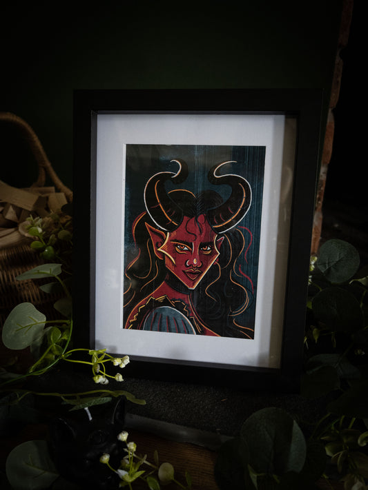 Close-up of The Horned Temptress framed print – bold gothic demon portrait with golden eyes and flowing dark hair by Sophie Atkinson