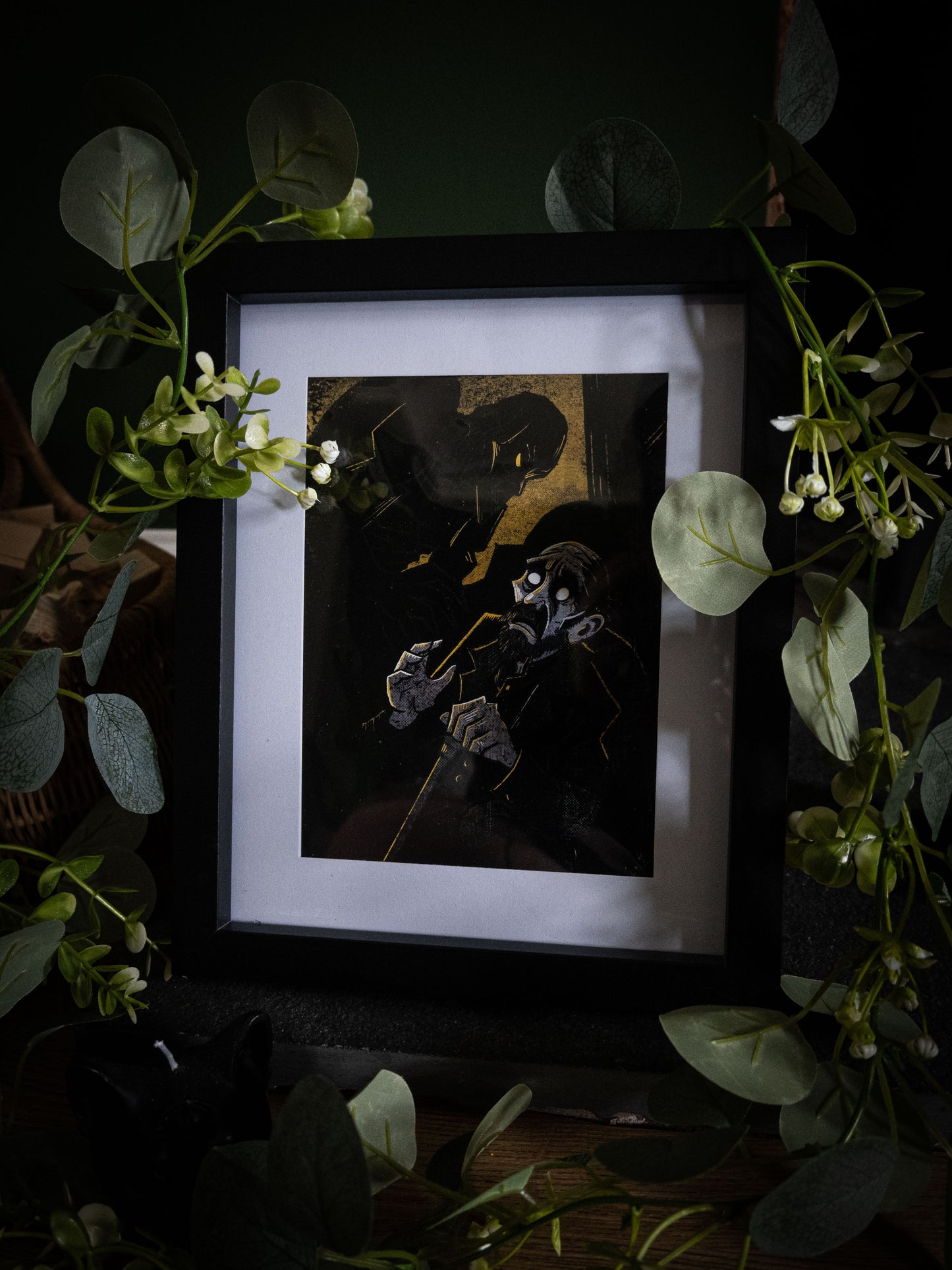 Framed gothic art print of De Lacey the blind man with a looming amber shadow behind him, from Sophie Atkinson's Frankenstein Illustrated series