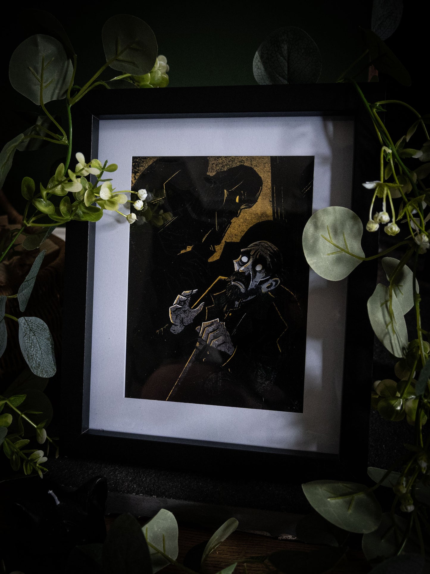 The Blind Man giclée print displayed with greenery — De Lacey clutching papers, amber and black gothic artwork from Frankenstein Illustrated