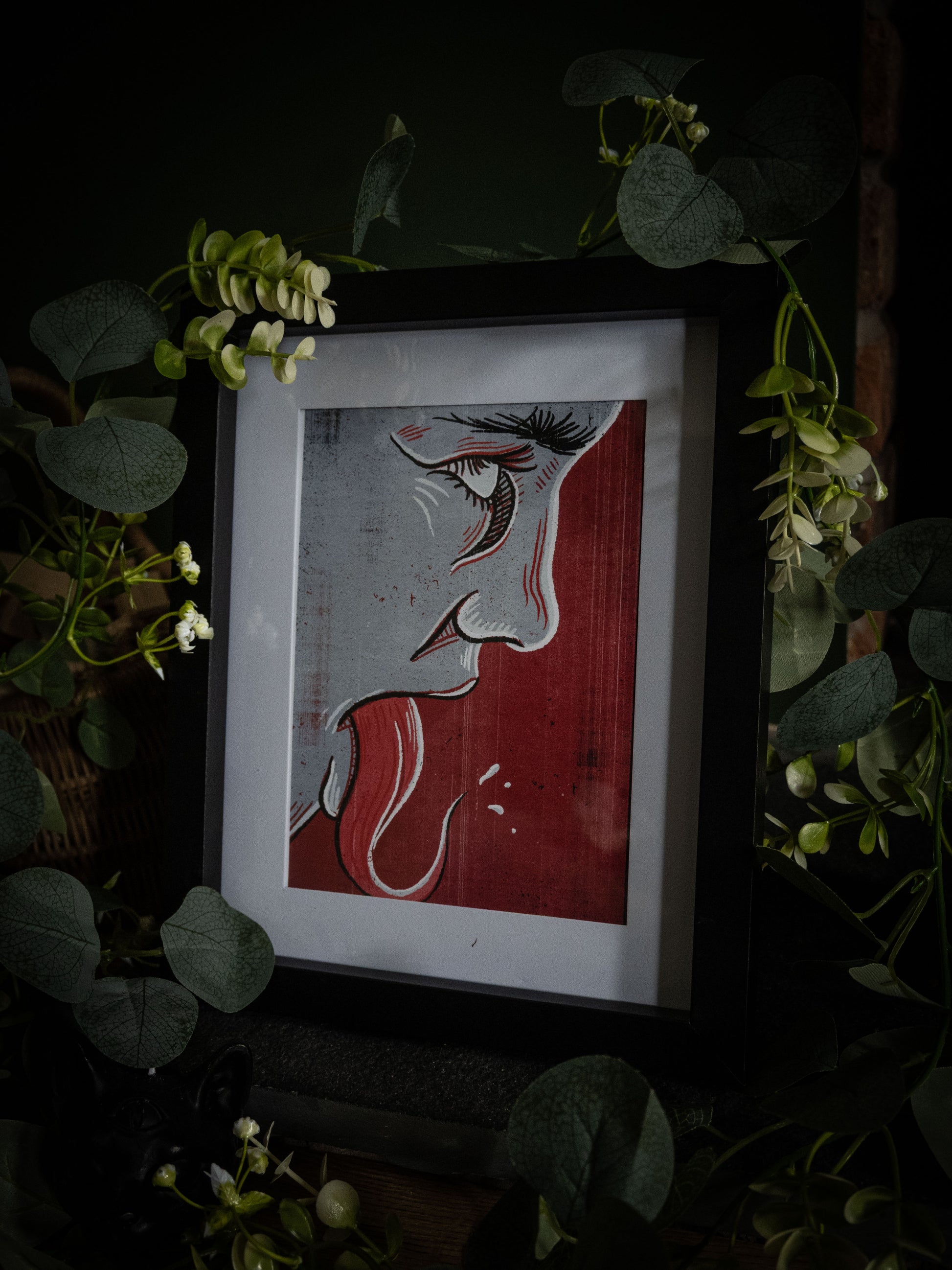 Speak No Evil gothic horror print – bold black linework profile with elongated tongue on crimson background