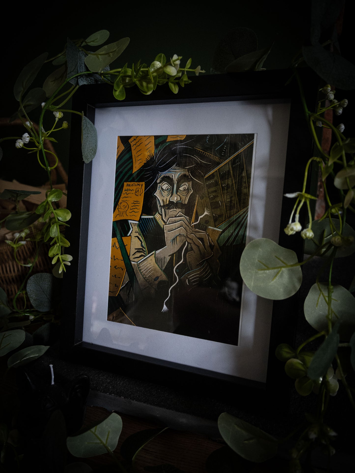 Framed colour art print of Victor Frankenstein sewing by candlelight, surrounded by anatomy notes, from Sophie Atkinson's Frankenstein Illustrated series