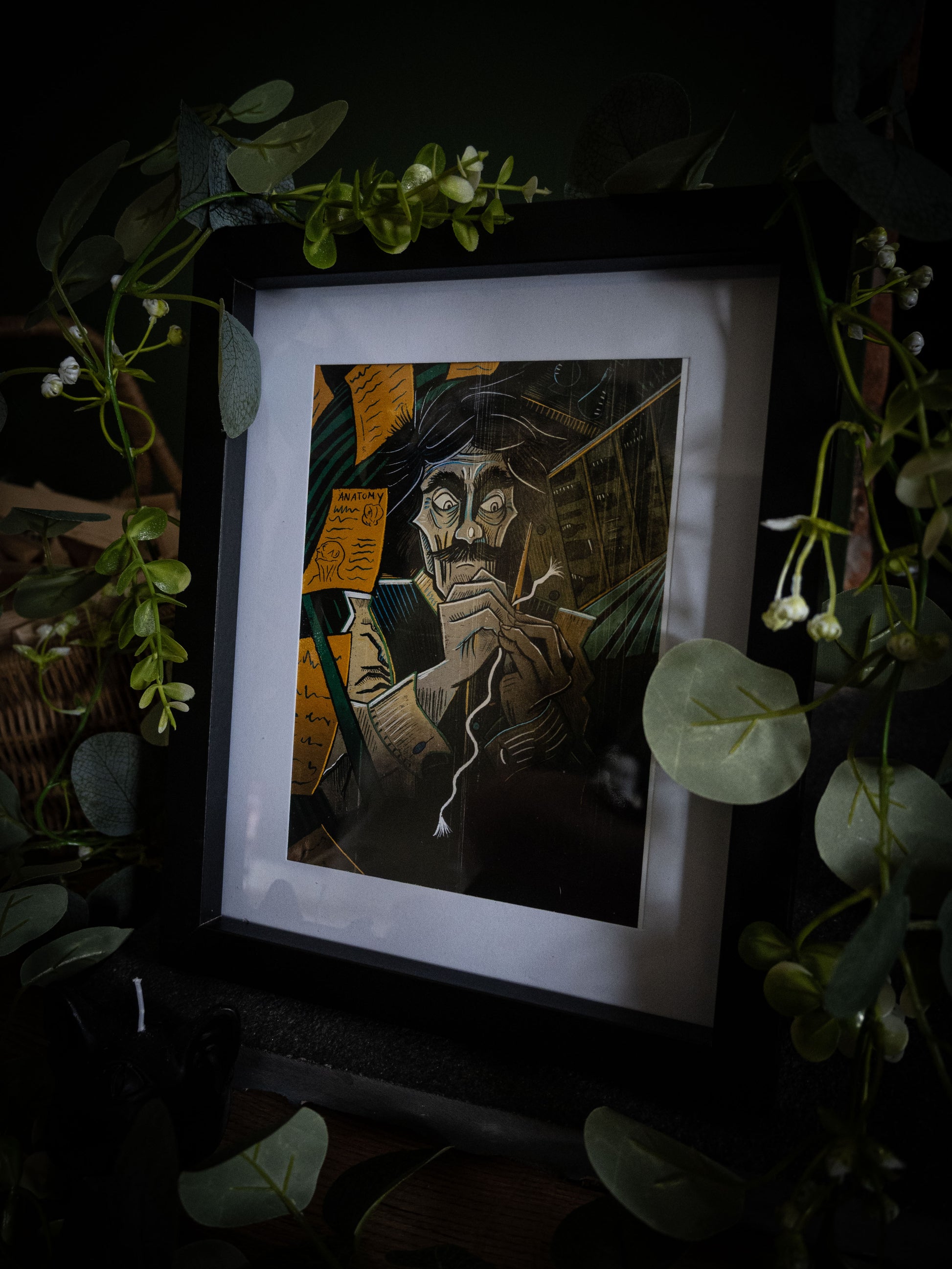 Framed colour art print of Victor Frankenstein sewing by candlelight, surrounded by anatomy notes, from Sophie Atkinson's Frankenstein Illustrated series