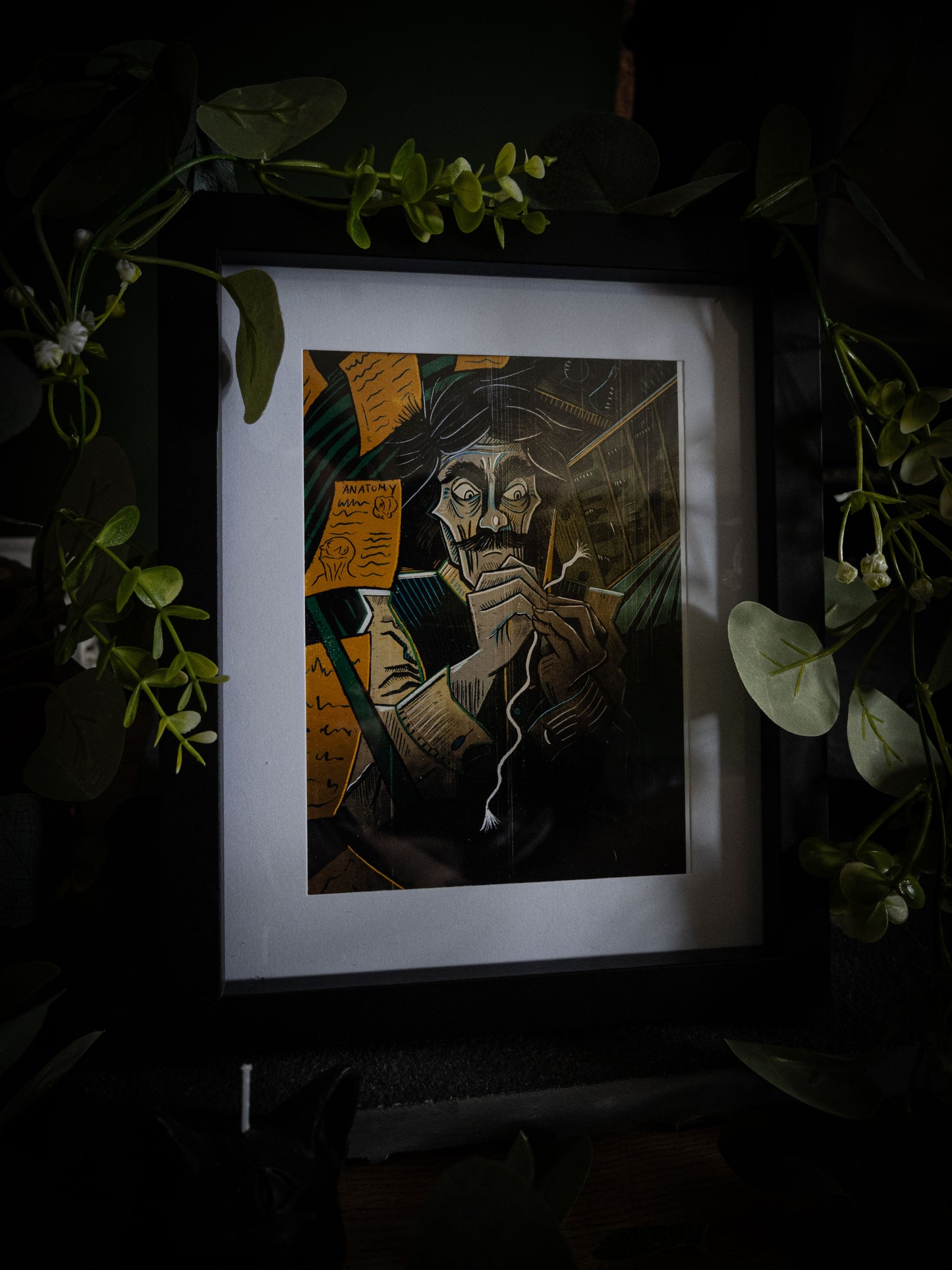 Victor giclée print displayed with greenery — wild-eyed Victor Frankenstein at work with needle and thread, colour gothic artwork by Sophie Atkinson